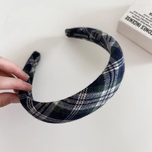 Detail of handmade green plaid wool headband with premium vintage fabric texture