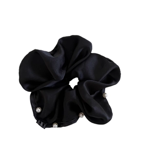 Elegant black satin scrunchie with white pearl accents and silk texture for ponytails