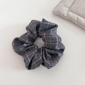 Pink and grey plaid fabric scrunchie with soft ruffled texture for high top hair styling