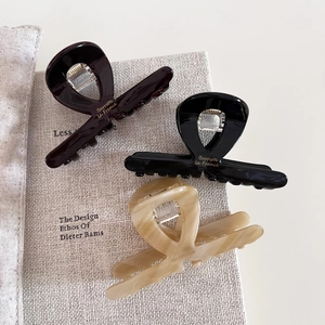 Three-piece acetate hair claw clips set in chocolate, cream, and black marble colors