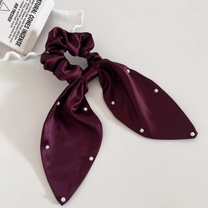 Elegant wine red satin scrunchie with long pearl-embellished bow on white background