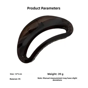Detailed view of large crescent hair claw showing its 12x5cm dimensions and amber texture