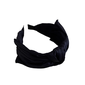 Serre-tête large noir élégant avec design à nœud central et finition texture soie