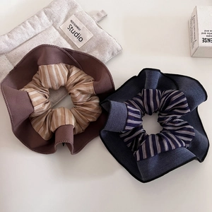 Detail of striped fabric hair scrunchies in coffee and denim blue with premium stitching