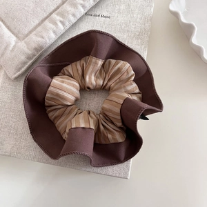Retro striped fabric scrunchie with layered beige and brown ruffles for ponytail styling