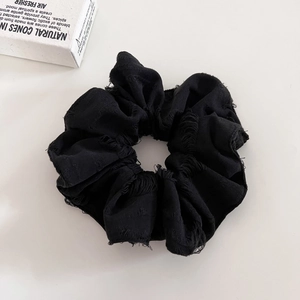 Vintage black distressed scrunchie with frayed edges and retro wasteland style aesthetic