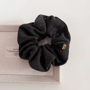 Vintage black polka dot corduroy scrunchie with metal charm and branded woven label