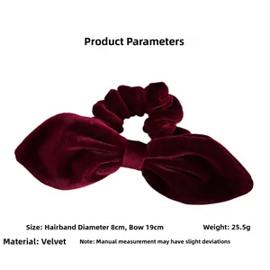 Detail view of burgundy velvet bow hair scrunchie showing 19cm width and 8cm diameter
