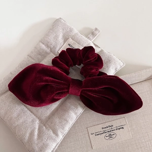 Elegant vintage burgundy velvet bow scrunchie with a soft texture for stylish hair styling