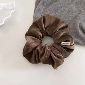 Retro velvet scrunchie in deep brown with handmade label for elegant hair styling