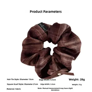 Brown plaid scrunchie with bow detail and metal heart charm including dimensions 15cm