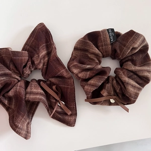 Vintage brown plaid scrunchie set with bow detail and heart pendant on white surface