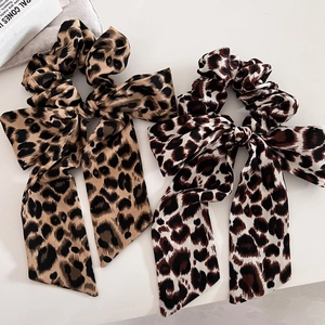 Detail of leopard print scrunchies with long ribbons in brown and khaki chiffon fabric