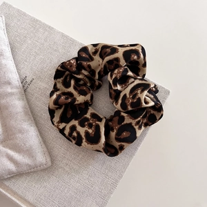 Vintage leopard print scrunchie in silk-like satin fabric for stylish ponytail hairstyles