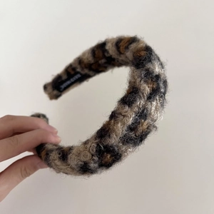 Thick plush leopard print headband with soft lambswool texture and handmade label