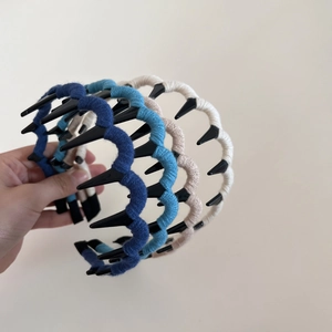 Three-piece set of knitted wavy headbands with teeth in navy, blue-grey, and cream
