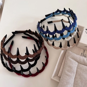 Knitted wool wrapped headband with black spikes for high-volume hair styling in multiple colors
