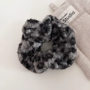 Close-up of the plush faux fur texture on a grey leopard print oversized scrunchie