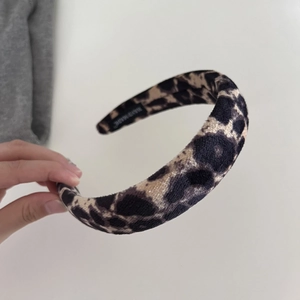 Premium leopard print velvet headband with handmade label and soft plush texture