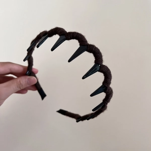 Detail showing deep brown yarn-wrapped wavy headband with non-slip inner teeth