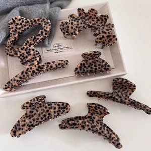 Retro leopard print acetate hair claws in various shapes displayed on a beige tray
