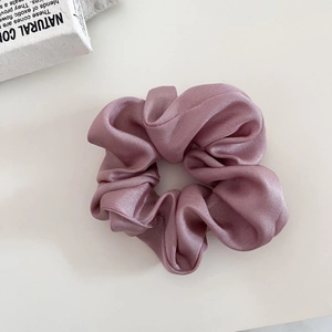 Elegant mauve satin scrunchie with a silky finish for high-end ponytail styling
