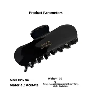 Detail of 10x5cm black acetate hair claw clip showing size, weight, and gold engraving