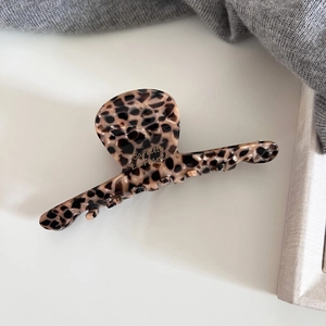 Close-up of leopard print acetate hair claw with Barrette La France gold lettering