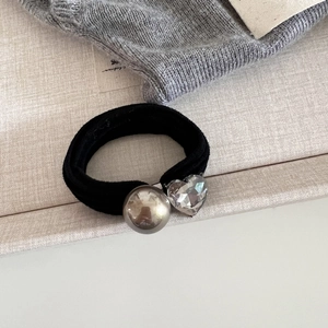 Détail d'un élastique à cheveux haute élasticité avec perle argentée et cristal en cœur