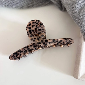 Close-up of leopard pattern hair claw with Barrette La France text and metal spring