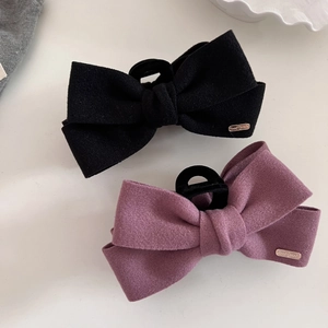 Elegant wool fabric bow hair claw clips in black and pink with gold handmade metal labels