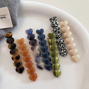 Detail of sweet acetate heart hair clips in various marble and tortoiseshell patterns