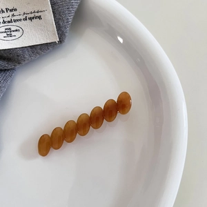 Elegant amber brown acetate oval bead hair clip for women in a vintage minimalist style