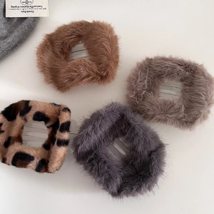 Detail of four plush faux fur hair claws in brown, grey and leopard print for autumn