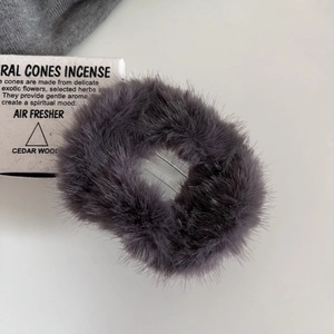 Detail shot of fluffy faux fur hair claw clip in dark grey with soft texture