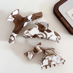 Elegant 4-piece hair clip set with brown marble acetate textures and minimalist style