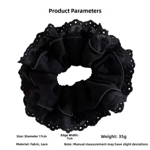 Macro view of 17cm large black lace scrunchie with detailed hollow floral patterns
