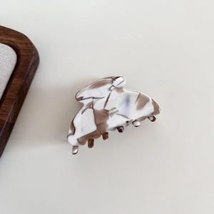 Close-up of marble pattern acetate hair claw clip with spring teeth mechanism