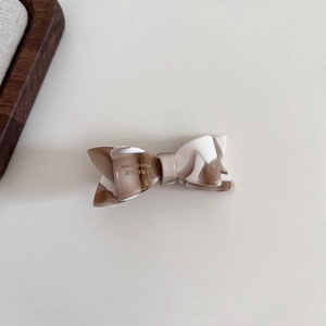 Detail of milk coffee marbled acetate hair claw clip with France Handmade lettering