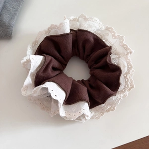 Detail showing vintage lace edge and ribbed coffee fabric texture on the hair scrunchie