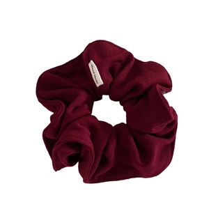 Retro burgundy knit scrunchie with vertical ribbed texture and Hand Made label