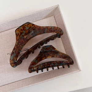 Detail of tortoiseshell acetate hair claws with gold France Handmade logo engraving