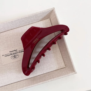 Detailed view of dark burgundy large hair claw clip with golden France Handmade logo