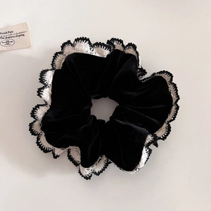 Vintage black velvet scrunchie with crochet lace trim for retro low ponytail hairstyles