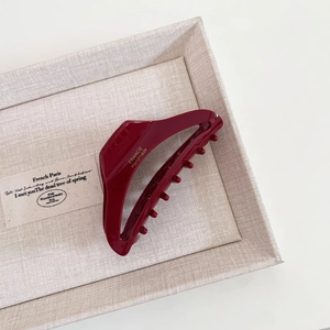Detailed close-up of dark red acetate hair claw clip showing France Handmade engraving