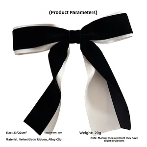 Close-up of contrast velvet and satin bow hair clip with alloy spring clasp detail