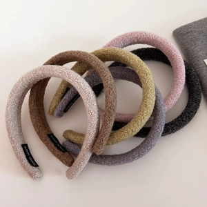 Thick plush lamb wool headbands in various colors with handmade label and soft texture