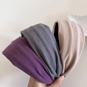 Three-piece set of thick knitted headbands in purple, grey, and beige for women