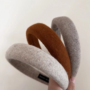 Thick wool padded headbands set in rust red and oatmeal grey with soft sponge texture
