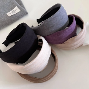 Close-up of wide padded headbands in various colors with a matte suede-like fabric finish
